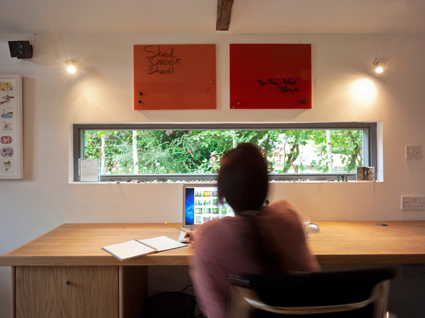 Garden Office / Gallery / Den internal joinery detail / desk and window with person