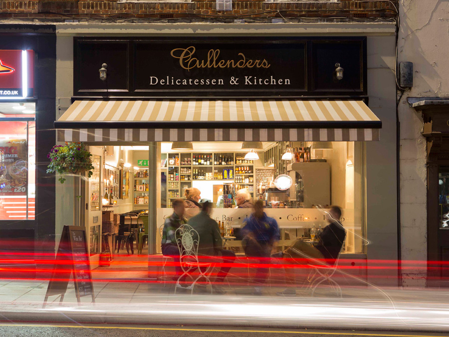 Cullender's Delicatessen's restaurant, winebar external view at night with people and traffic lights
