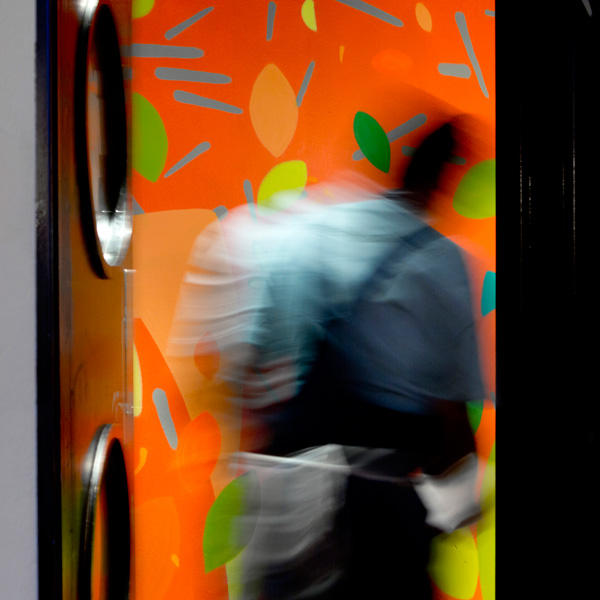 Tootoomoo restaurantdoor to kitchen with painted walls and person